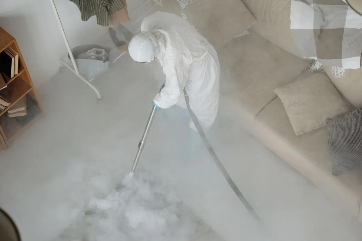 Biohazard cleanup technician in protective equipment, Dellwood, MO